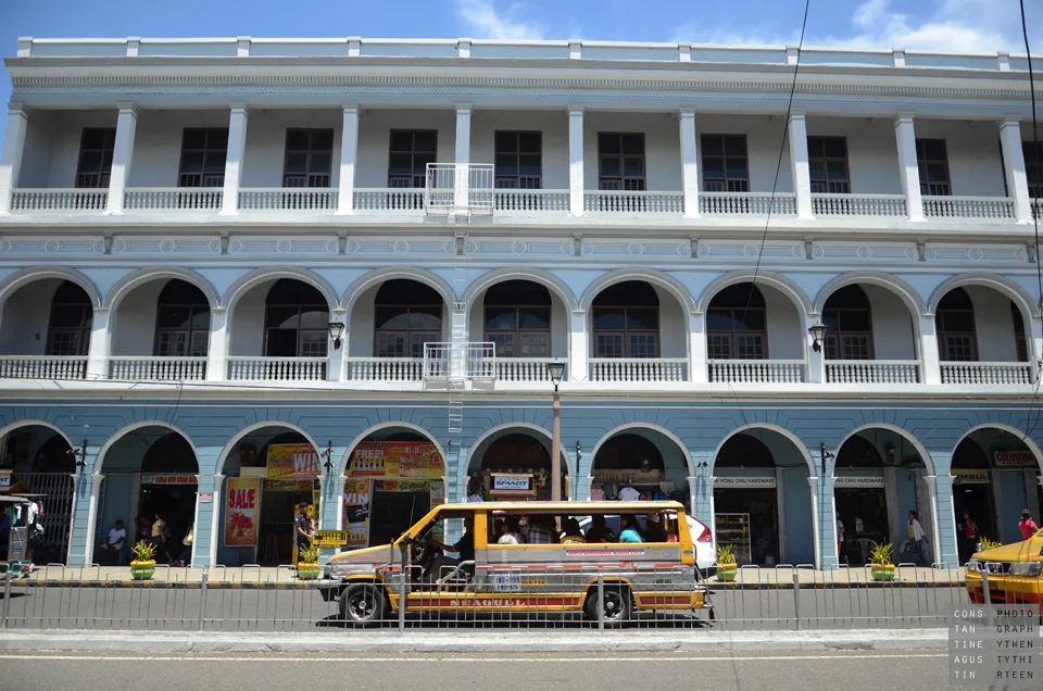 A yellow jeepney passing the old arcaded building on J.M. Basa Street in downtown Iloilo City